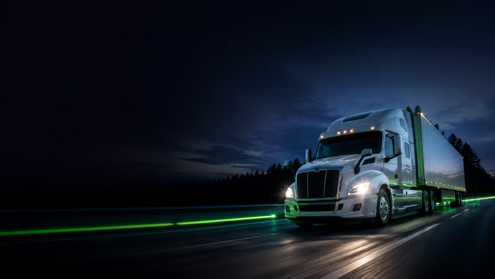 A semi truck moving along a highway at dusk